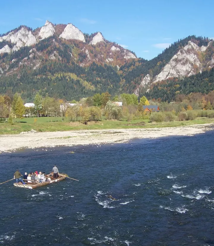 A traditional wooden raft on the Dunajec River beneath the Pieniny mountains