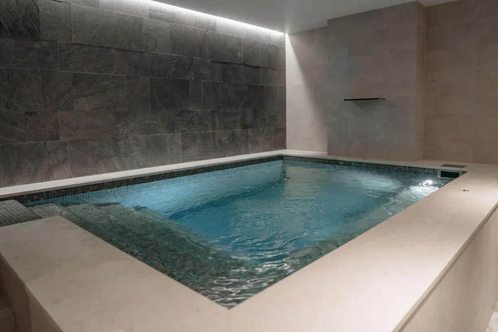 A blue indoor pool in a spa, illustrating the thermal-bath experience