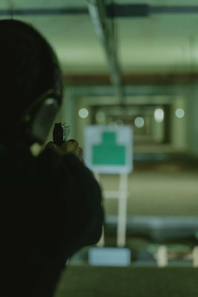 A person practising with a handgun at an indoor shooting range