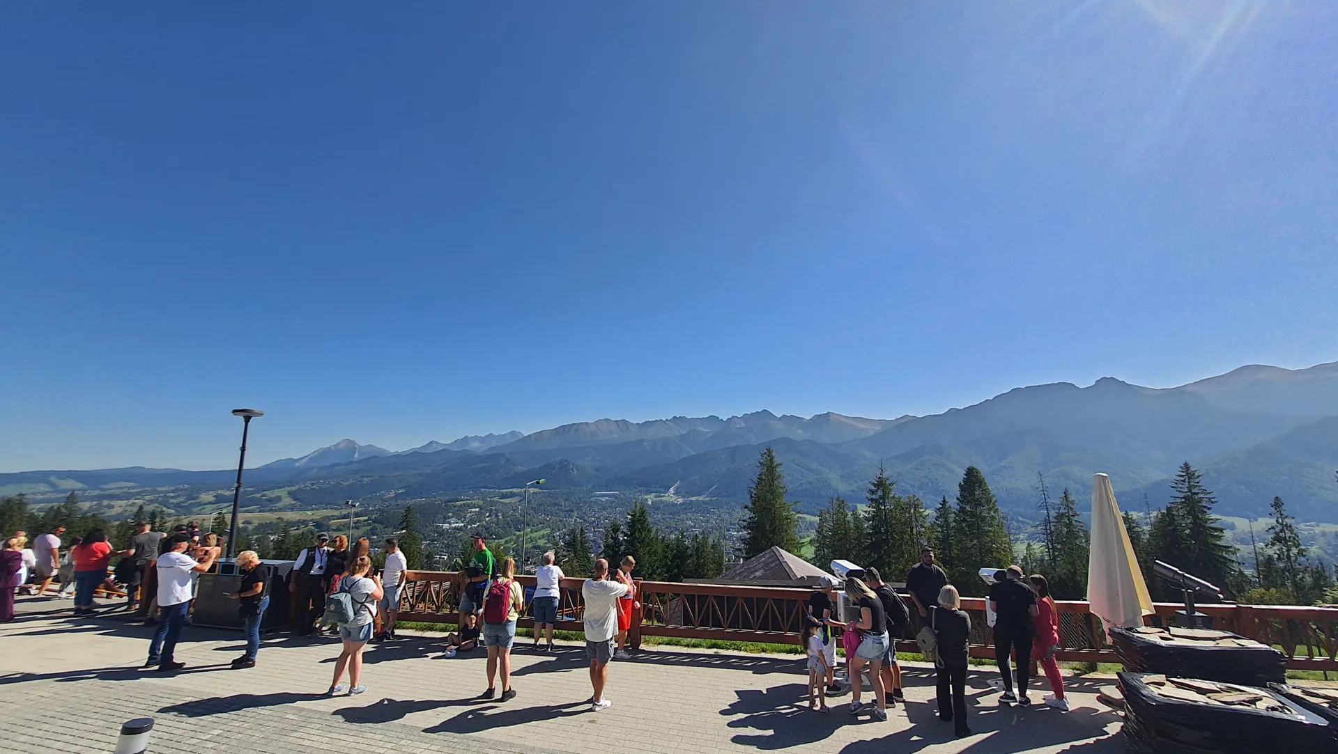 Visitors enjoying a panorama of the Tatra mountains from a Zakopane viewpoint