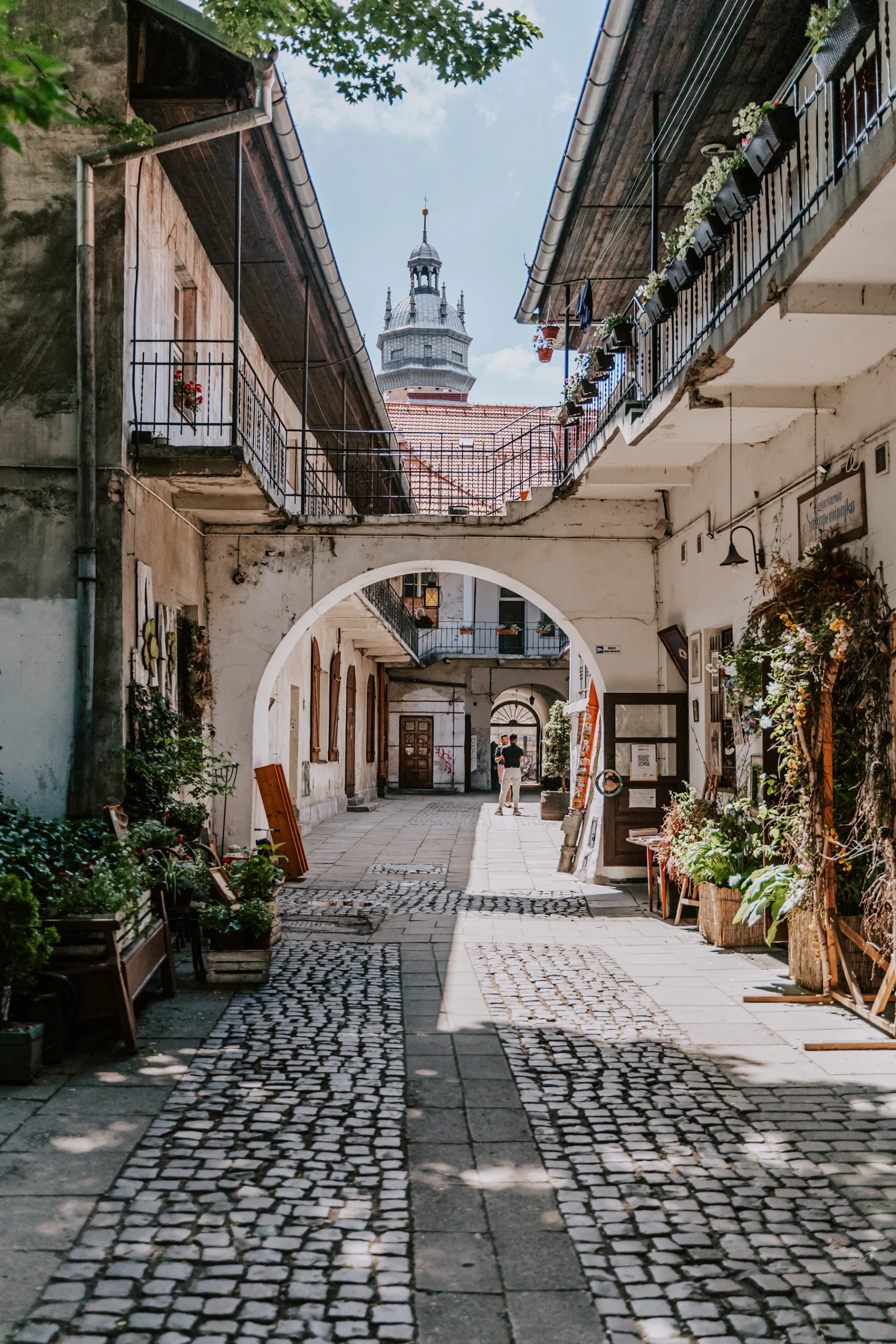 Cobblestone courtyard with arches and balconies in Kazimierz, Krakow