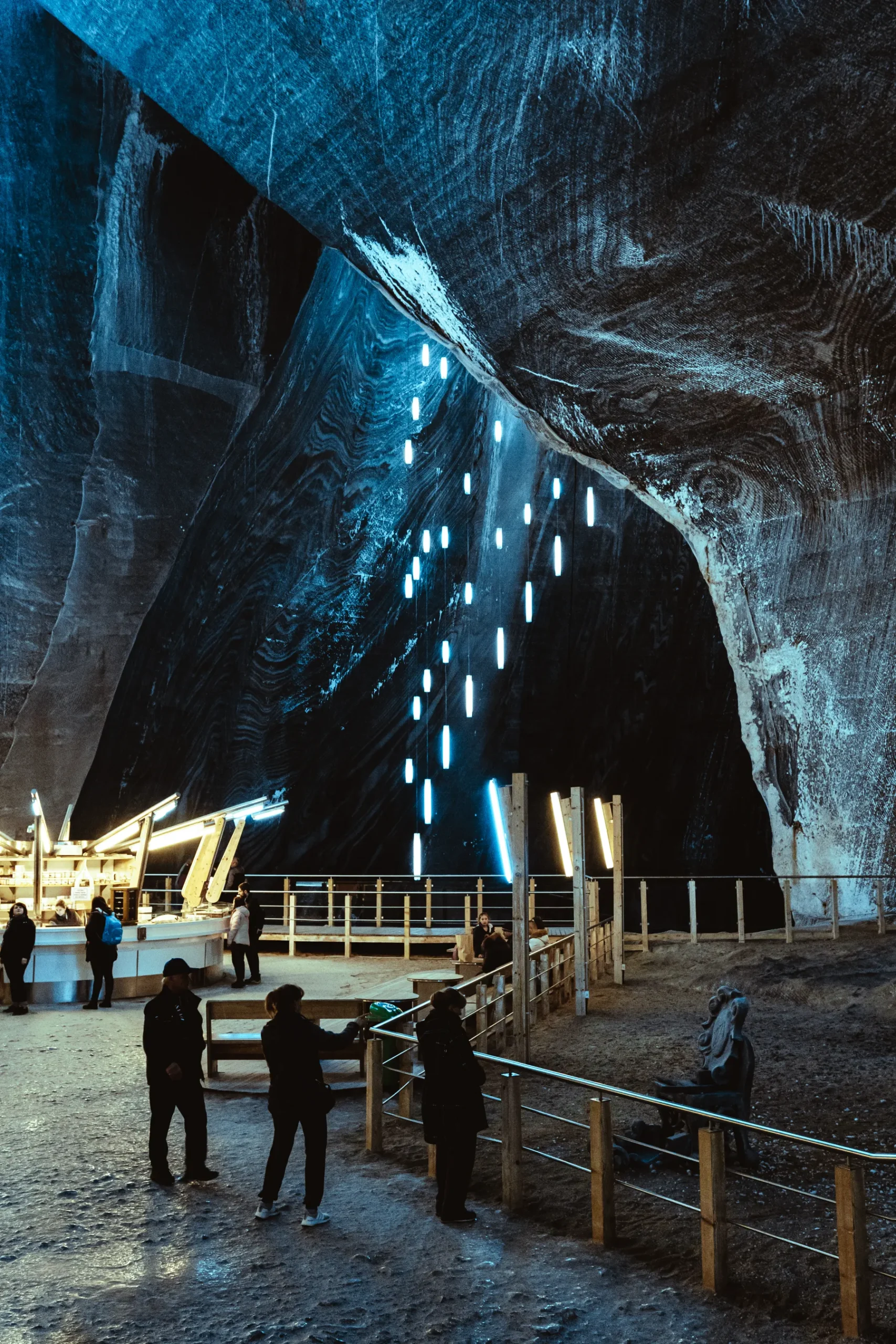 Visitors inside an illuminated underground chamber at Wieliczka Salt Mine